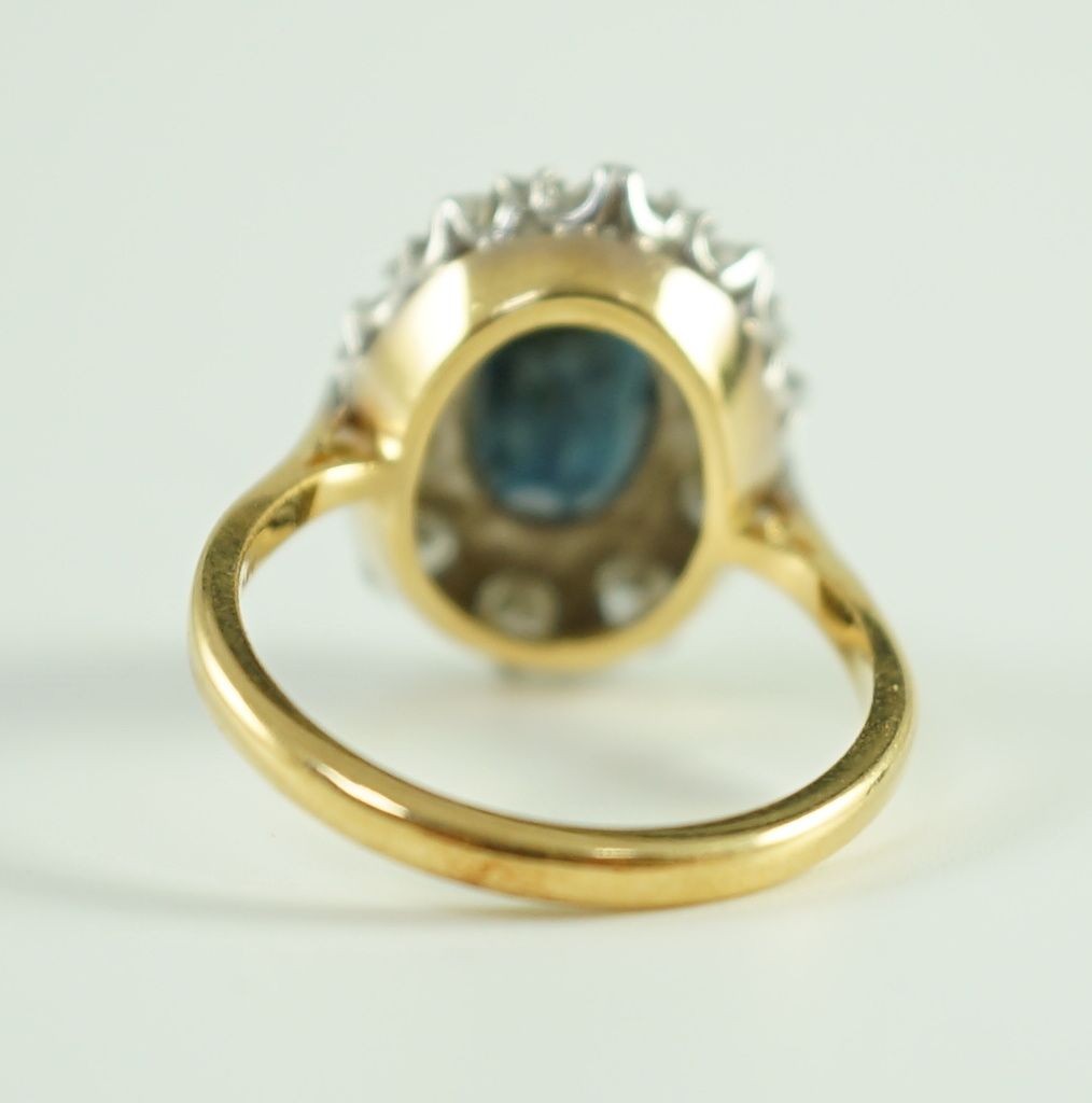 An 18ct gold, sapphire and diamond set oval cluster dress ring